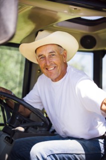 Portrait of smiling Caucasian farmer in tractor