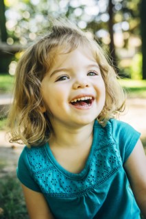Portrait of laughing Caucasian preschool girl