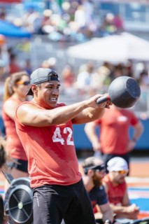 Man lifting kettlebell outdoors