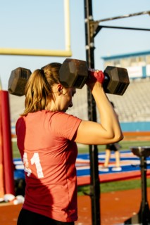 Caucasian woman lifting weights outdoors