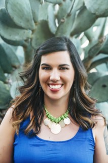 Portrait of smiling Mixed Race woman near cactus
