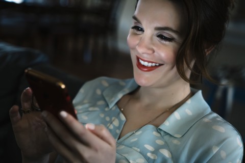 Woman texting on cell phone in the dark