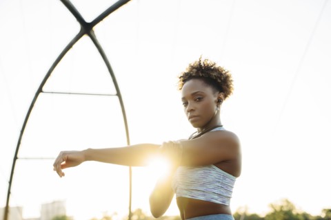 Portrait of mixed race woman stretching arms