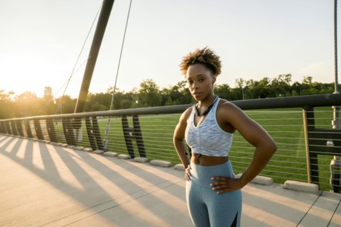 Mixed race woman resting on bridge