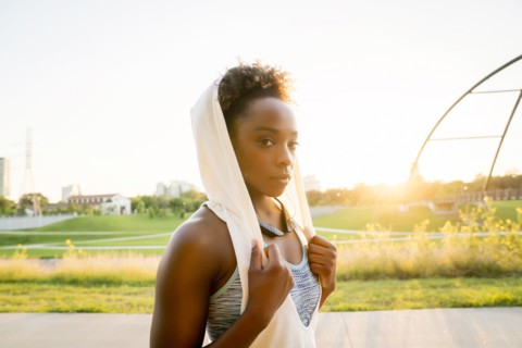 Mixed race woman resting with towel on head
