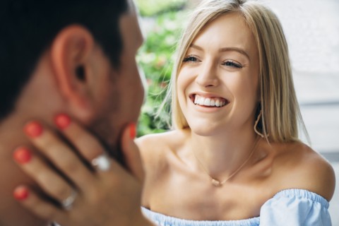 Smiling Caucasian woman embracing man