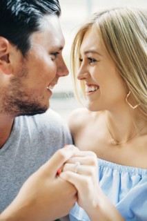 Smiling Caucasian couple holding hands