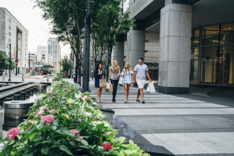 Friends carrying shopping bags in city