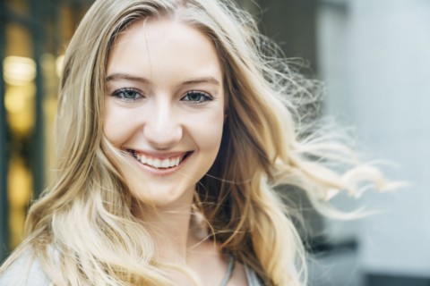 Wind blowing hair of smiling Caucasian woman