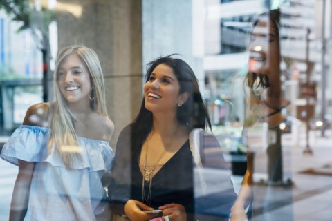 Smiling women window shopping