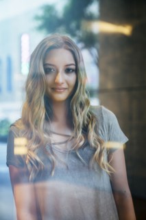 Portrait of serious Caucasian woman behind window