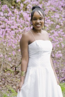Mixed race woman wearing dress in garden