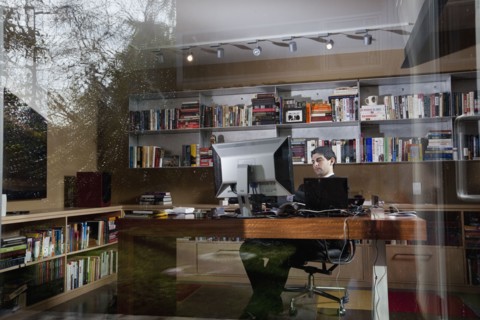 Mixed race businessman sitting at desk
