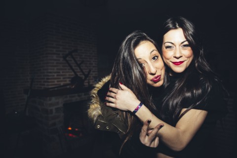Smiling women hugging at party