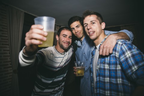 Smiling men drinking in nightclub