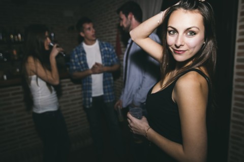 Smiling woman dancing in nightclub