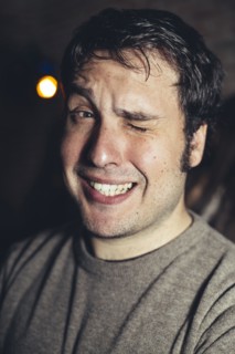 Close up of Hispanic man winking