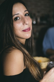 Close up of Hispanic woman drinking in nightclub