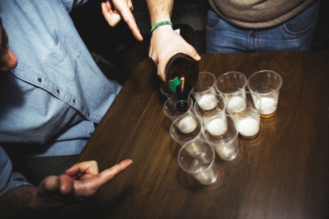 Man pouring drinks at party