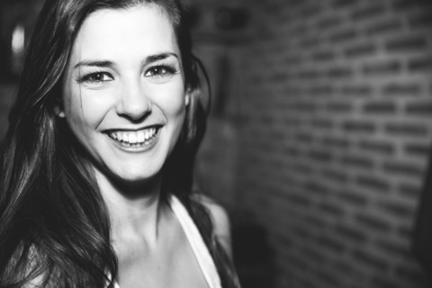 Smiling Caucasian woman laughing in nightclub