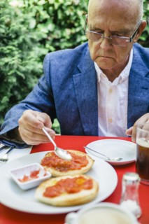 Hispanic businessman eating breakfast outdoors