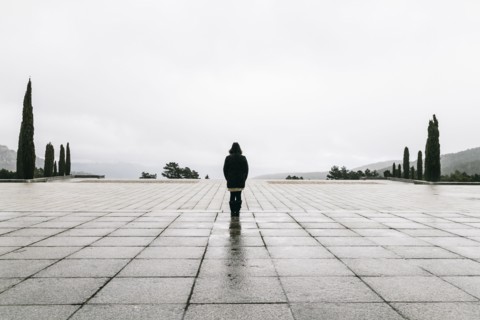 Caucasian woman walking in concrete courtyard