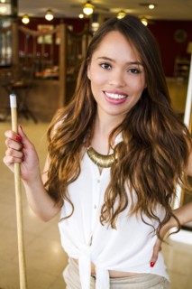 Hispanic woman holding pool cue