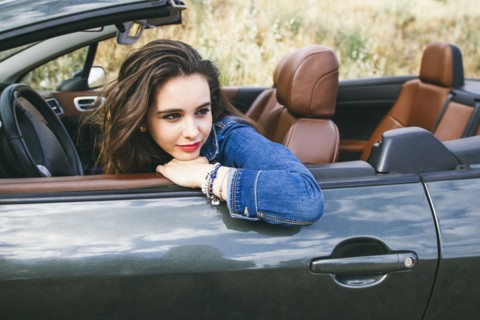 Caucasian woman sitting in convertible