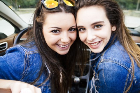 Women smiling in convertible