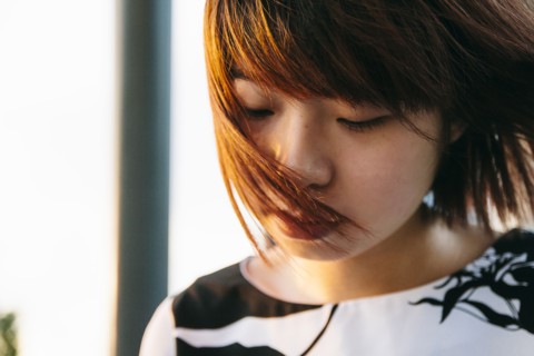 Hair of Chinese woman blowing in wind