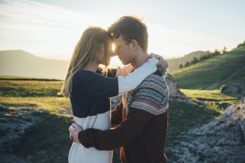 Caucasian couple rubbing noses and hugging