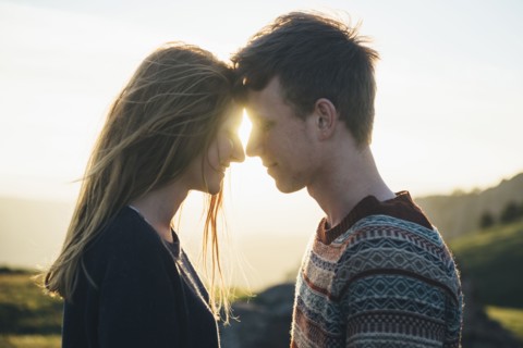 Caucasian couple face to face in landscape