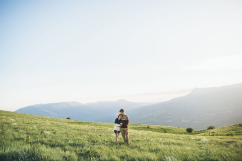 Caucasian couple hugging in field