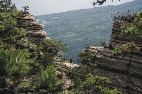 Distant Caucasian man standing in mountain landscape