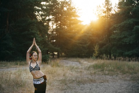 Caucasian belly dancer in field
