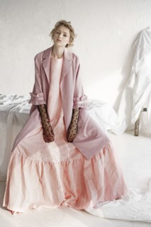Portrait of serious Caucasian woman wearing pink dress