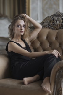 Glamorous Caucasian woman sitting in armchair