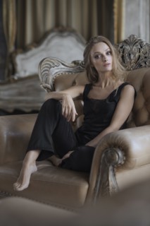 Glamorous Caucasian woman sitting in armchair