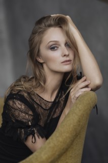 Portrait of glamorous Caucasian woman sitting on sofa