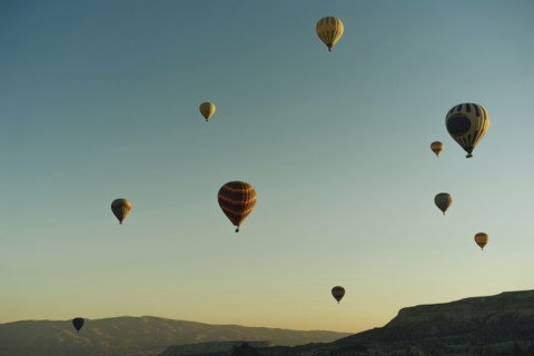 Hot air balloons flying at sunset