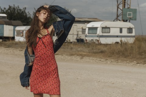Frustrated Caucasian woman standing near trailers