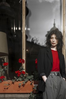 Caucasian woman leaning on flower box near window