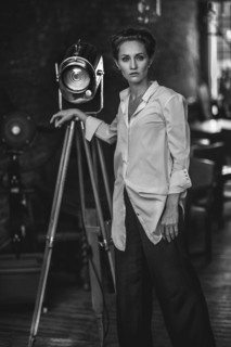 Serious Caucasian woman standing near light