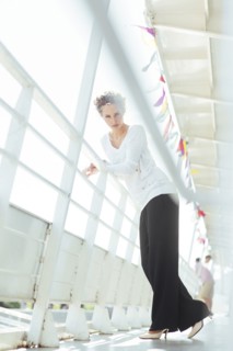 Glamorous Caucasian woman leaning on railing