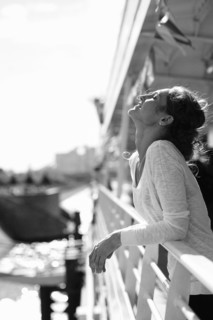Caucasian woman relaxing and leaning on railing