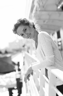 Portrait of smiling Caucasian woman leaning on railing
