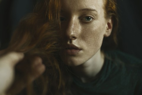 Caucasian woman holding hair