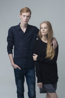 Portrait of serious Caucasian couple hugging