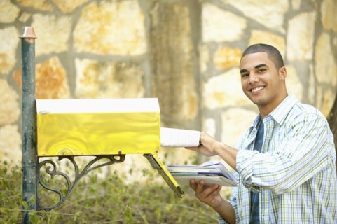 Man getting mail from mailbox