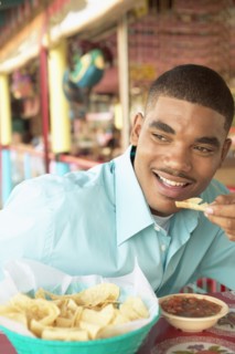 Man eating chips and salsa